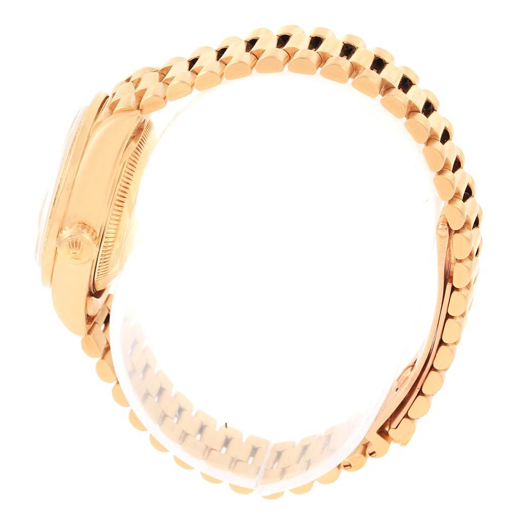 The image shows a side view of a Rolex President 69138 Women's Yellow Gold Champagne Dial 69138 Women's Yellow Gold Champagne Dial model watch, highlighting the crown, case, and the bracelet.