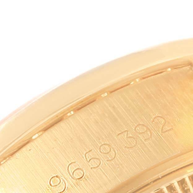 This image shows a close-up of the serial number on the side of the case of a Rolex President 69138 Women's Yellow Gold Champagne Dial 69138 Women's Yellow Gold Champagne Dial model watch.