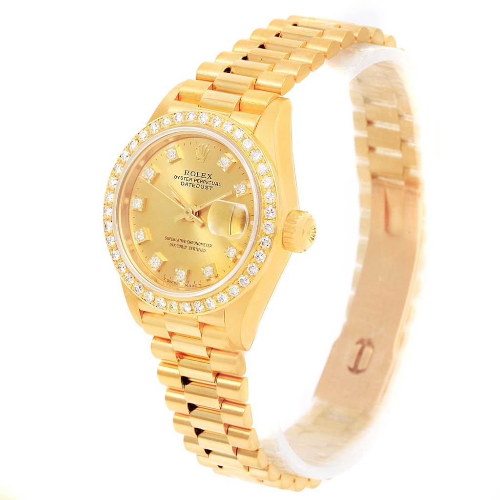 The image shows a Rolex President 69138 Women's Yellow Gold Champagne Dial 69138 Women's Yellow Gold Champagne Dial model watch at an angled view, highlighting the gold band, dial, bezel, and crown.
