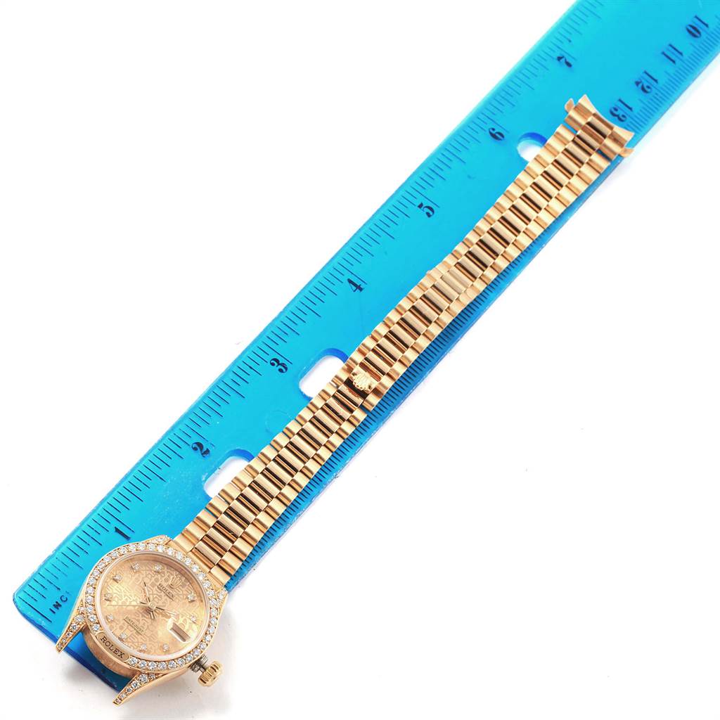 The Rolex President 69158 Women
s Yellow Gold Champagne Dial 69158 Women
s Yellow Gold Champagne Dial model watch is shown flat with its band extended parallel to a ruler for scale.