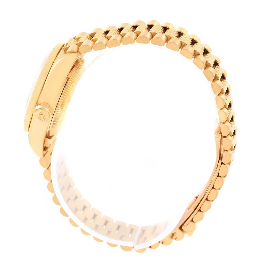 The Rolex President 69288 Women's Yellow Gold Champagne Dial 69288 Women's Yellow Gold Champagne Dial model watch is shown from a side angle, highlighting the gold case, crown, and part of the bracelet.