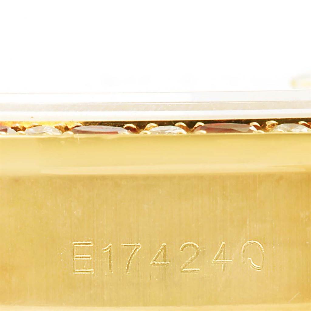 This image shows a close-up of the engraved serial number on the side of a Rolex President 69198 Women's Yellow Gold Champagne Dial 69198 Women's Yellow Gold Champagne Dial model watch case.