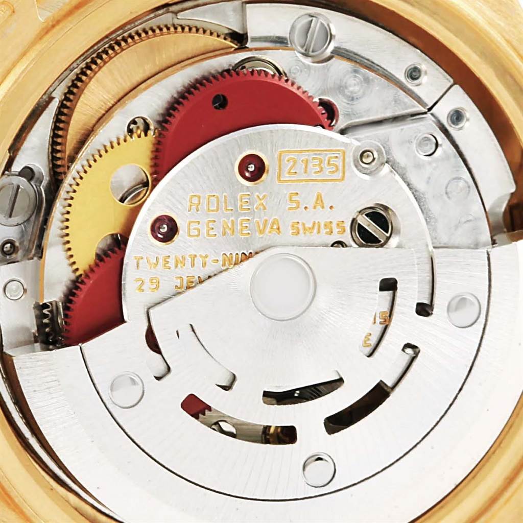 The image shows the internal movement mechanism of a Rolex President 69198 Women's Yellow Gold Champagne Dial 69198 Women's Yellow Gold Champagne Dial model watch, highlighting its intricate gears and components.