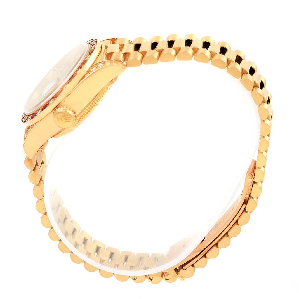 The image shows the side view of a Rolex President 69198 Women's Yellow Gold Champagne Dial 69198 Women's Yellow Gold Champagne Dial model watch, focusing on the clasp, bezel, and crown.