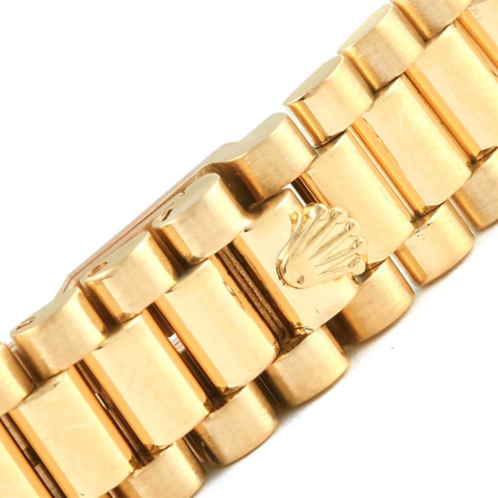 This image shows a close-up of the gold bracelet watch band clasp of the Rolex President 69198 Women's Yellow Gold Champagne Dial 69198 Women's Yellow Gold Champagne Dial model.