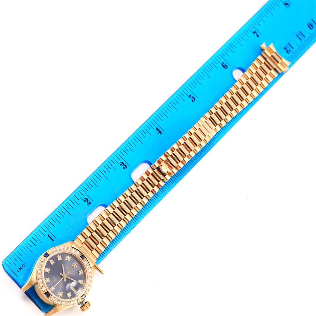 The Rolex President 69088 Women's Yellow Gold Blue Dial 69088 Women's Yellow Gold Blue Dial model watch is shown from a top view, displaying the face and the full length of the bracelet alongside a ruler for measurement.