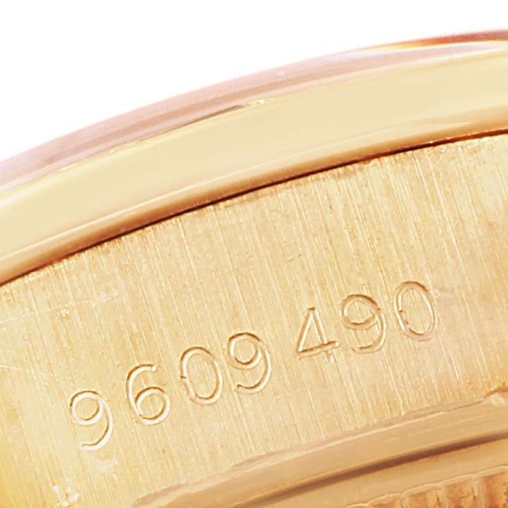 This close-up image shows the engraved serial number on the case back of a Rolex President 69088 Women's Yellow Gold Blue Dial 69088 Women's Yellow Gold Blue Dial model watch.