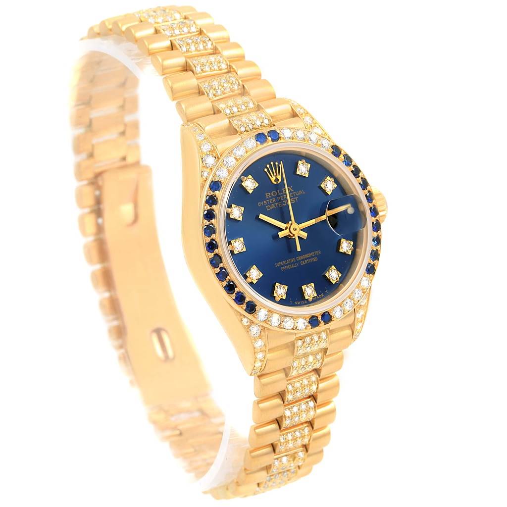 The image shows a Rolex President 69038 Women's Yellow Gold Blue Dial 69038 Women's Yellow Gold Blue Dial watch with a gold bracelet, blue dial, and diamond accents, viewed from a three-quarter angle.