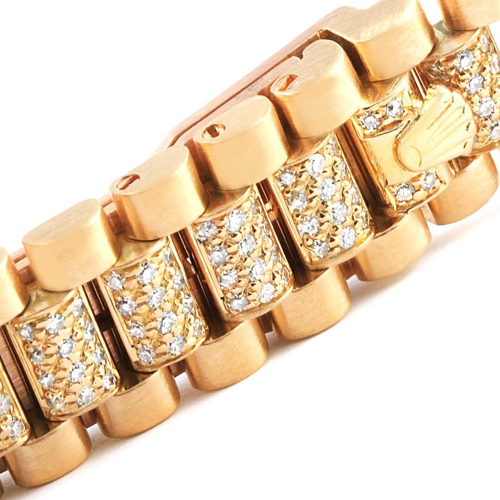 This close-up image shows the diamond-encrusted bracelet links of a Rolex President 69038 Women's Yellow Gold Blue Dial 69038 Women's Yellow Gold Blue Dial model watch.