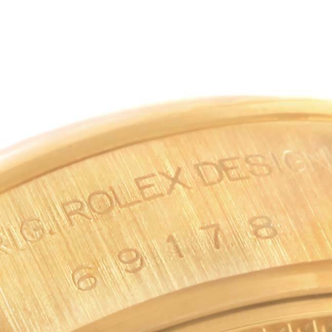 This close-up image of a Rolex President 69178 Women's Yellow Gold Mother of Pearl Dial 69178 Women's Yellow Gold Mother of Pearl Dial model shows the engraved text "ORIG. ROLEX DESIGN" and part of the model number.