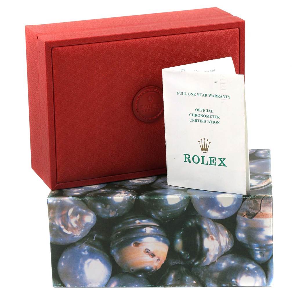 The image shows the packaging and warranty card for a Rolex President 69178 Women's Yellow Gold Mother of Pearl Dial 69178 Women's Yellow Gold Mother of Pearl Dial model watch from a slight angle.