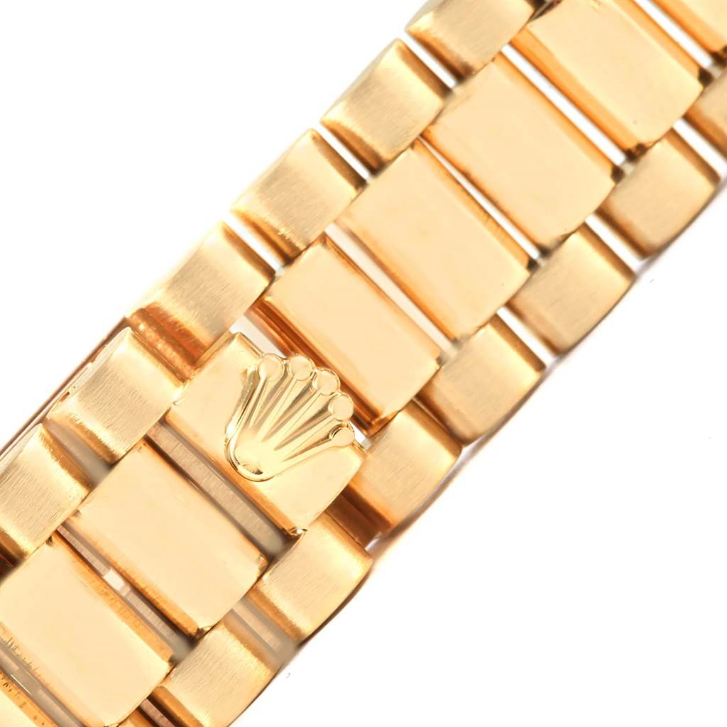 This image shows a close-up of the gold bracelet band with the Rolex logo on the President model by Rolex.