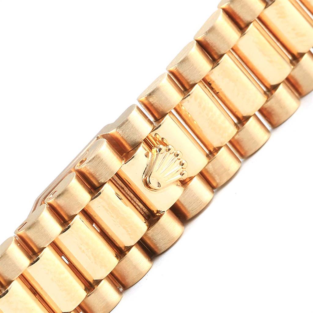 This image shows a close-up of the bracelet clasp of a Rolex President 79178 Women's Yellow Gold Silver Dial 79178 Women's Yellow Gold Silver Dial watch, featuring the Rolex crown logo.