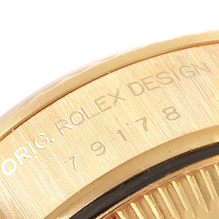 This close-up angle shows part of the bezel and engraving on the Rolex President 79178 Women's Yellow Gold Silver Dial 79178 Women's Yellow Gold Silver Dial model watch.