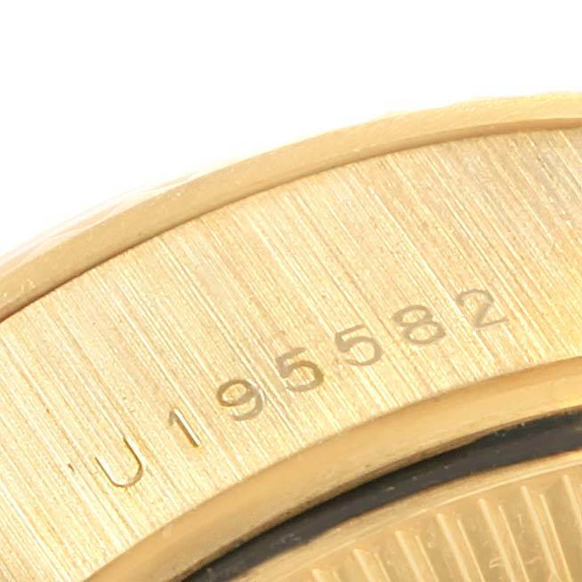 This close-up image of the Rolex President 79178 Women's Yellow Gold Silver Dial 79178 Women's Yellow Gold Silver Dial model watch shows part of the case and a section of the serial number.