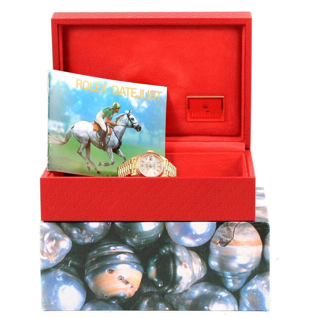 The image shows a Rolex President 79178 Women's Yellow Gold Silver Dial 79178 Women's Yellow Gold Silver Dial watch placed in an open red box with a Rolex Datejust booklet.