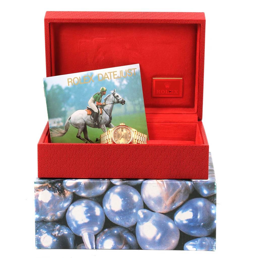 The image shows a Rolex President 69178 Women's Yellow Gold Champagne Dial 69178 Women's Yellow Gold Champagne Dial model watch in its box with a Rolex Datejust booklet.