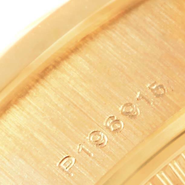 The image shows a close-up view of the serial number engraving on the gold case of a Rolex President 79138 Women's Yellow Gold Champagne Dial 79138 Women's Yellow Gold Champagne Dial model watch.