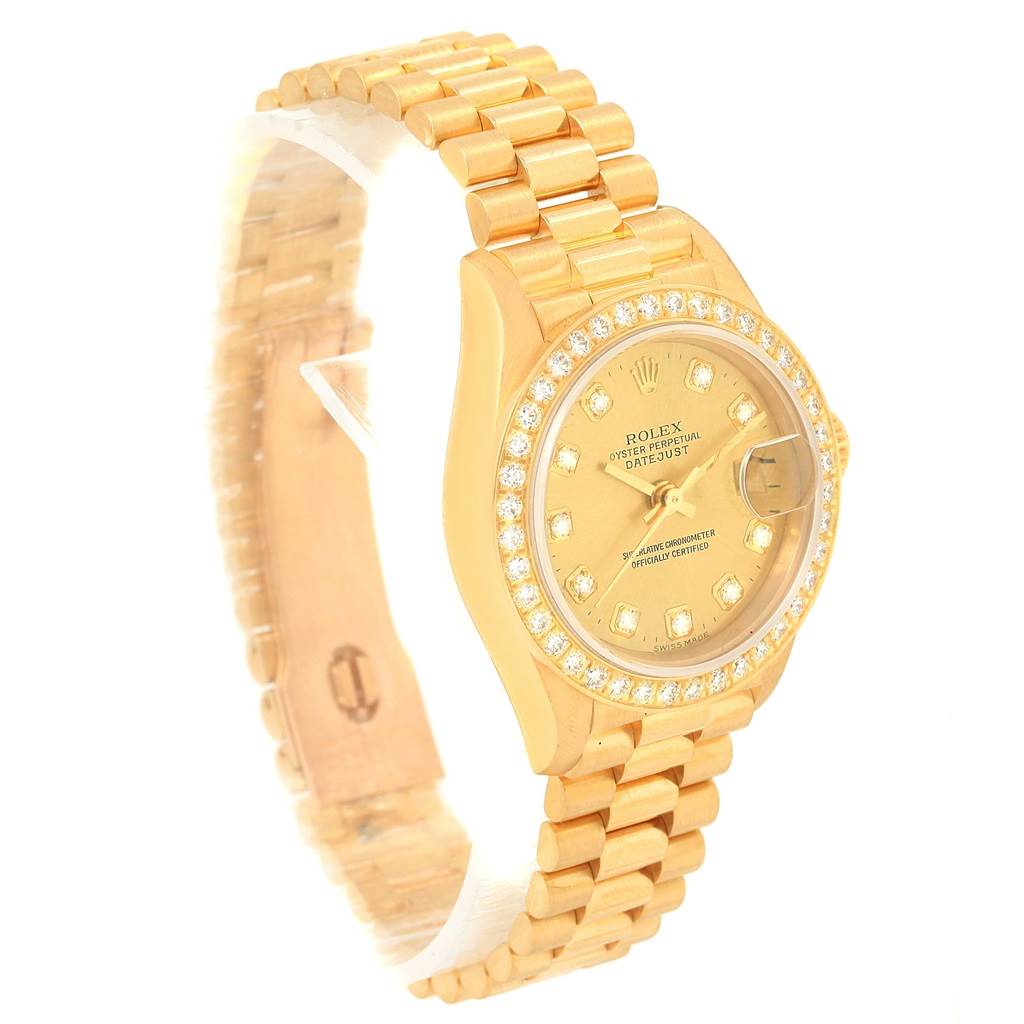This image shows a Rolex President 79138 Women's Yellow Gold Champagne Dial 79138 Women's Yellow Gold Champagne Dial watch from an angled side view, displaying its gold bracelet, case, and diamond-studded bezel and dial.