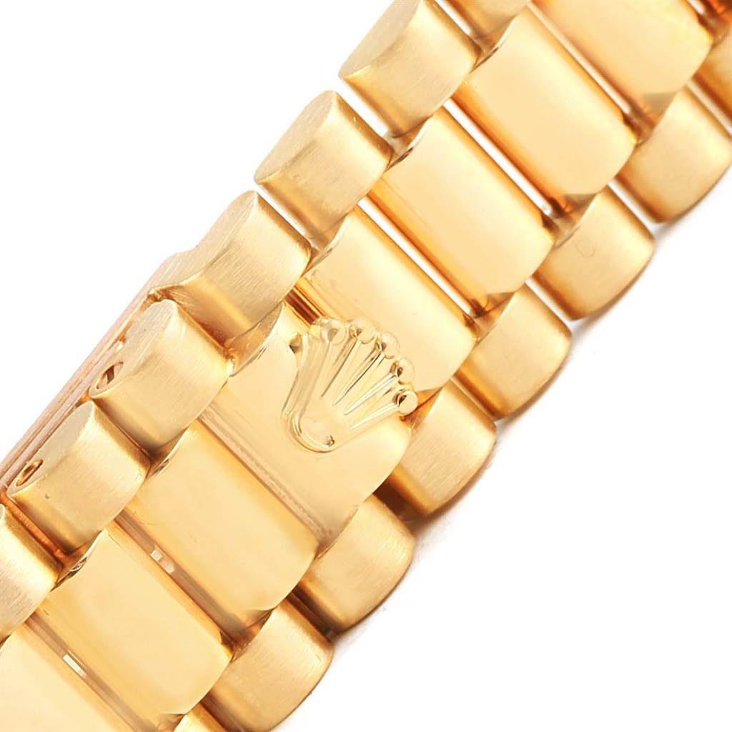 This image shows a close-up view of the bracelet links of a Rolex President 79138 Women's Yellow Gold Champagne Dial 79138 Women's Yellow Gold Champagne Dial model watch, highlighting the iconic Rolex crown logo.