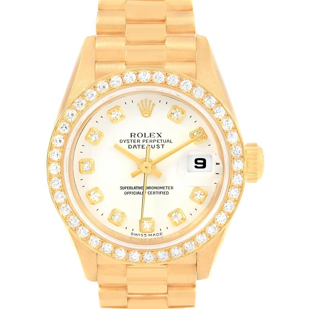 The image shows a frontal view of a Rolex President 79138 Women's Yellow Gold White Dial 79138 Women's Yellow Gold White Dial model, with a diamond-encrusted bezel, gold bracelet, date window, and logo visible.