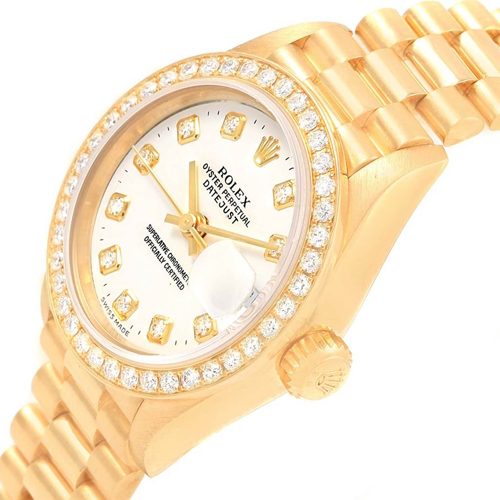 This image shows a close-up side angle of a Rolex President 79138 Women's Yellow Gold White Dial 79138 Women's Yellow Gold White Dial model, showcasing the dial, bezel with diamonds, and part of the bracelet.
