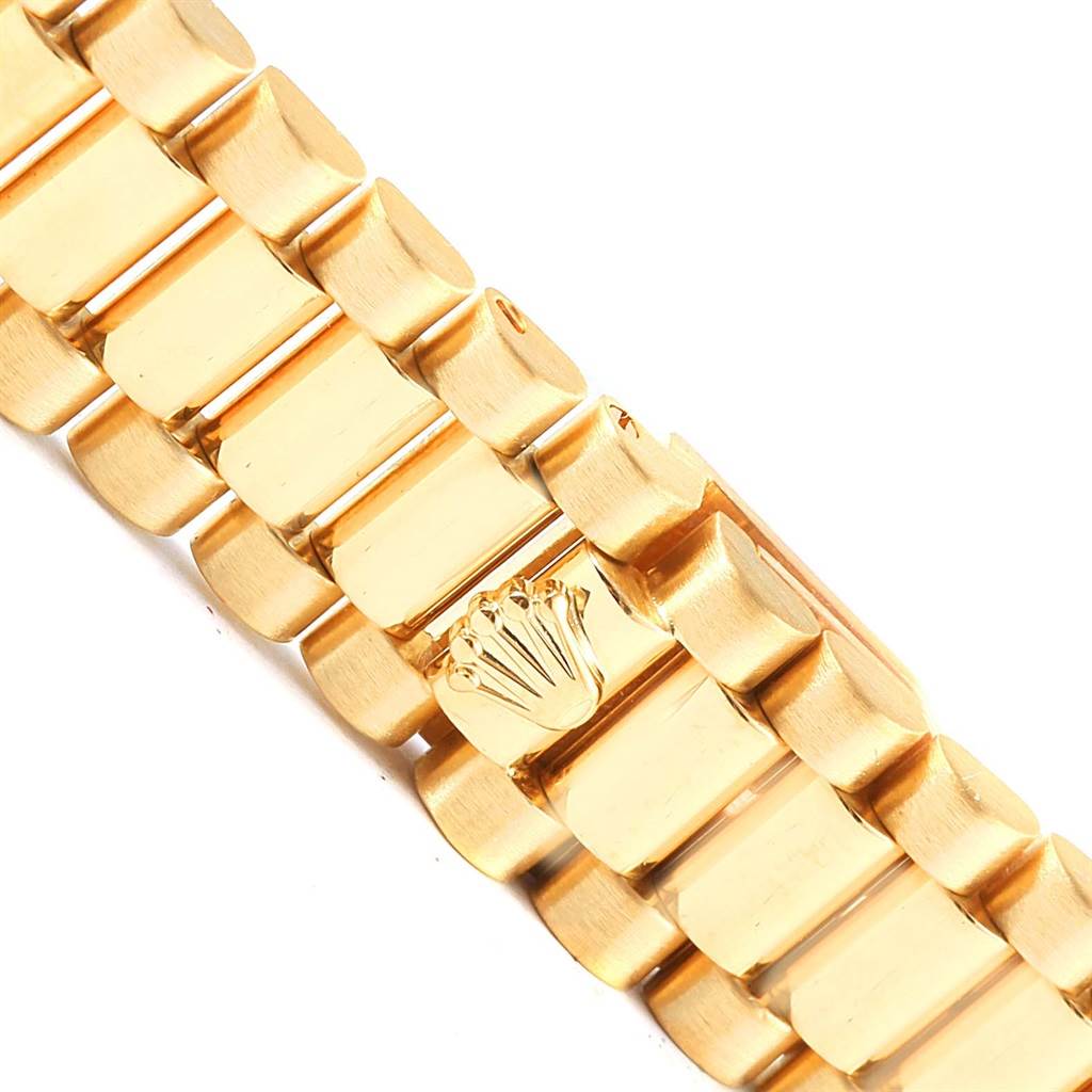 This image shows a close-up angle of the gold bracelet of a Rolex President 79178 Women's Yellow Gold White Dial 79178 Women's Yellow Gold White Dial model, highlighting the iconic crown logo.