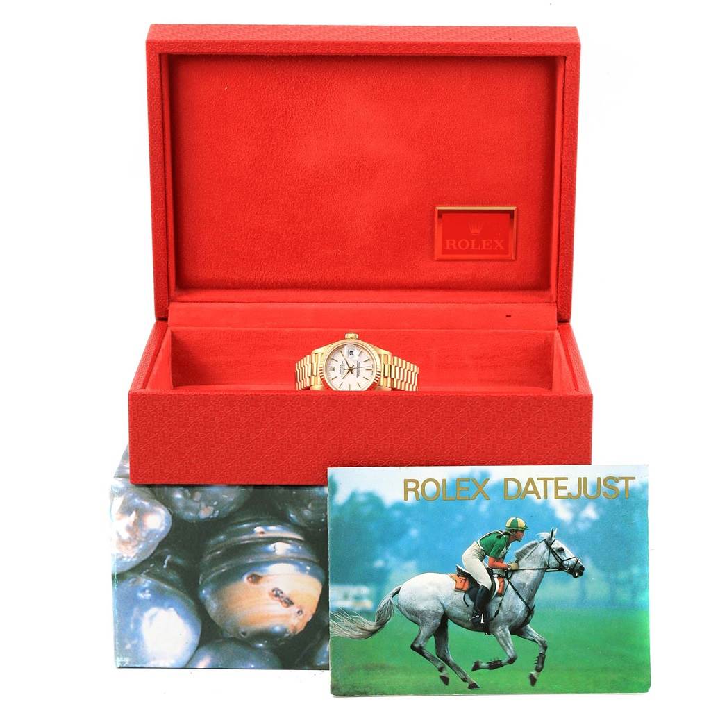 The Rolex President 79178 Women's Yellow Gold White Dial 79178 Women's Yellow Gold White Dial model watch is shown in its open red box with a Rolex Datejust booklet in front.
