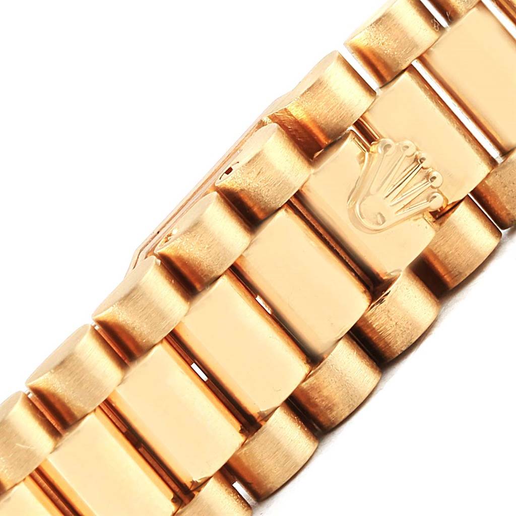 This close-up image shows the gold bracelet of a Rolex President 69158 Women's Yellow Gold Grey Dial 69158 Women's Yellow Gold Grey Dial model watch, highlighting the Rolex crown logo.