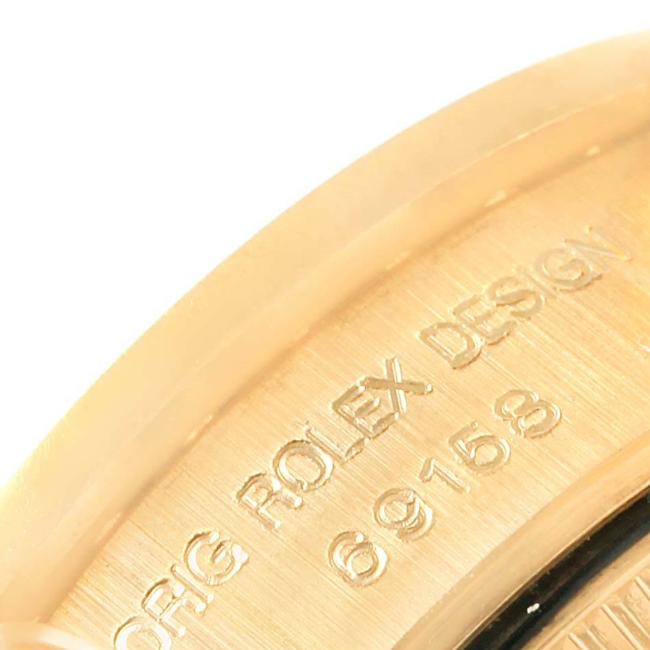 This image shows a close-up of the engraved serial number on the side of a Rolex President 69158 Women's Yellow Gold Grey Dial 69158 Women's Yellow Gold Grey Dial model.