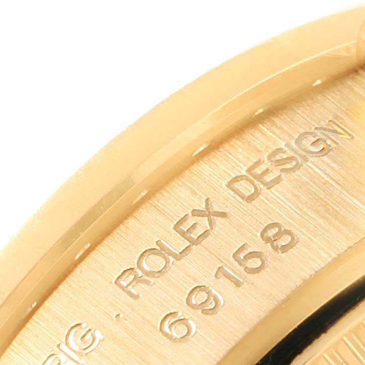 This is a close-up view of the case back of a Rolex President 69158 Women's Yellow Gold Champagne Dial 69158 Women's Yellow Gold Champagne Dial model, showing the model number and "ROLEX DESIGN" engraving.