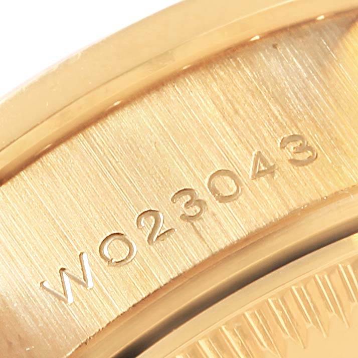 This image shows a close-up of the casing edge and serial number engraving on a Rolex President 69158 Women's Yellow Gold Champagne Dial 69158 Women's Yellow Gold Champagne Dial model watch.