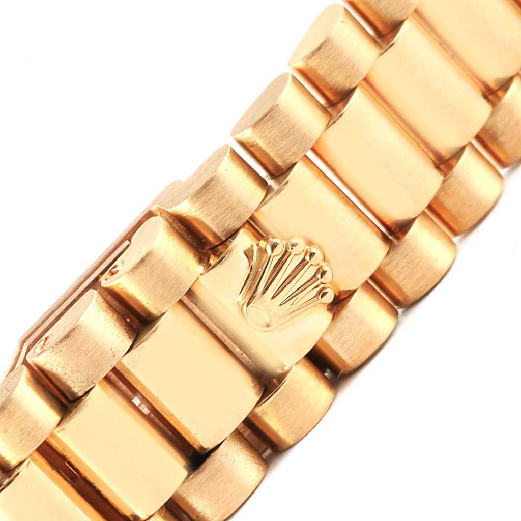 This image shows a close-up of the gold bracelet of the Rolex President 69158 Women's Yellow Gold Champagne Dial 69158 Women's Yellow Gold Champagne Dial model, featuring the iconic Rolex crown logo.