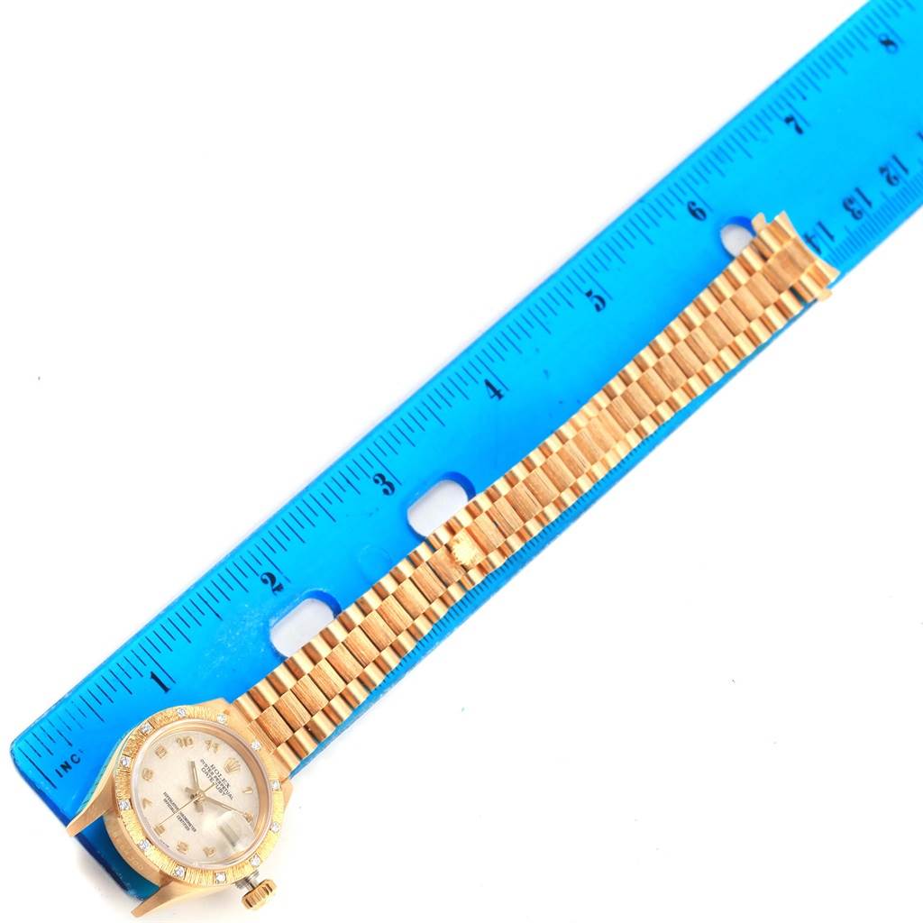 The image shows a Rolex President 69288 Women's Yellow Gold Beige Dial 69288 Women's Yellow Gold Beige Dial model watch from a top view, including the face and gold bracelet, alongside a blue ruler for scale.