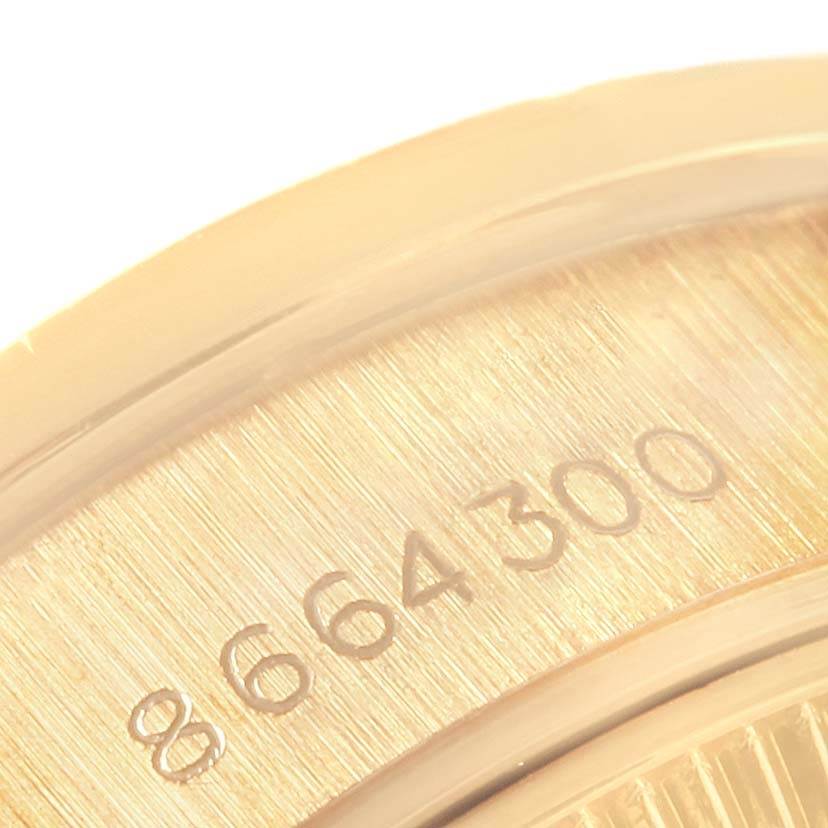 This close-up image shows the engraved numbers on the side of a Rolex President 69288 Women's Yellow Gold Beige Dial 69288 Women's Yellow Gold Beige Dial watch.