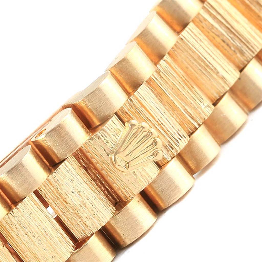 This is a close-up view of the gold bracelet of a Rolex President 69288 Women's Yellow Gold Beige Dial 69288 Women's Yellow Gold Beige Dial model watch, with the Rolex logo prominently displayed.