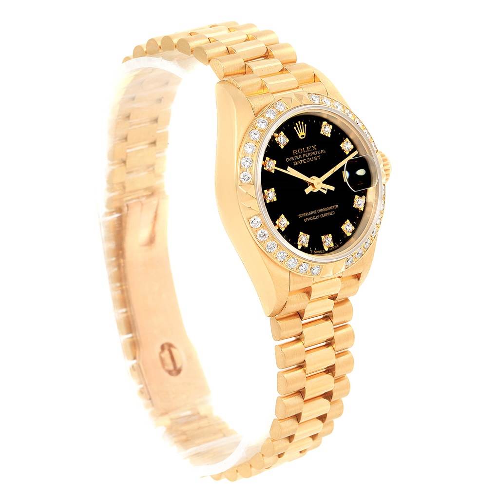 The image shows a Rolex President 69258 Women's Yellow Gold Black Dial 69258 Women's Yellow Gold Black Dial model watch at an angled side view, highlighting the black dial, diamond hour markers, and gold bracelet.