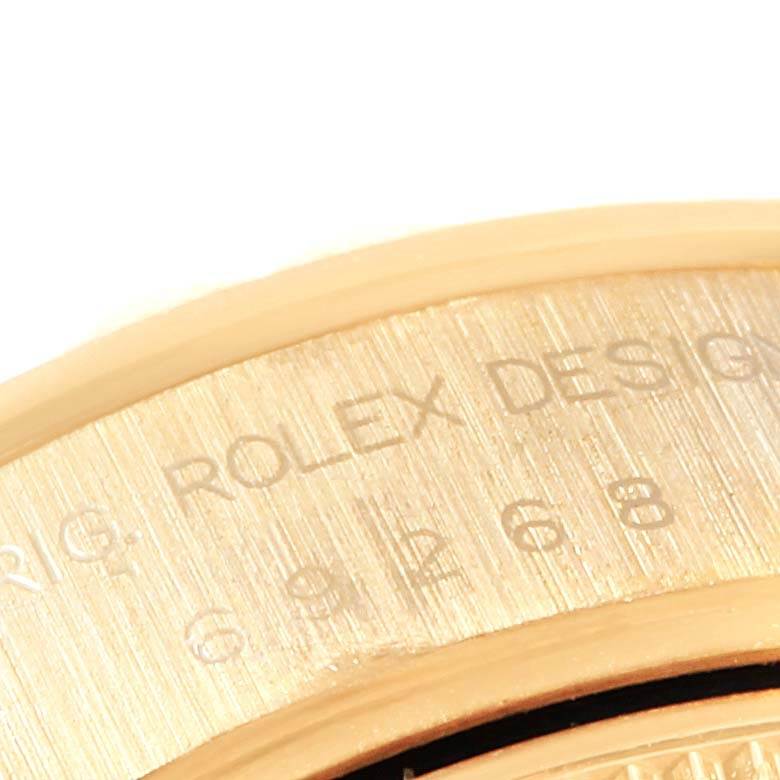 Close-up view of the case back of a Rolex President 69258 Women's Yellow Gold Black Dial 69258 Women's Yellow Gold Black Dial watch, showing part of the engraved model number.