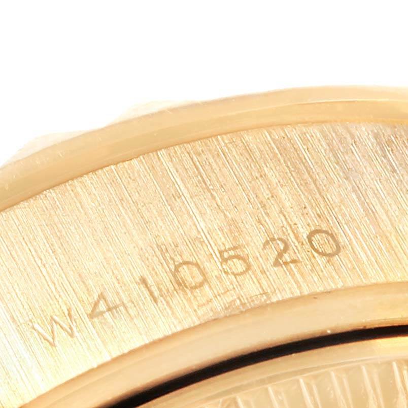 This image shows a close-up of the serial number engraving on the bezel of a Rolex President 69258 Women's Yellow Gold Black Dial 69258 Women's Yellow Gold Black Dial model watch.