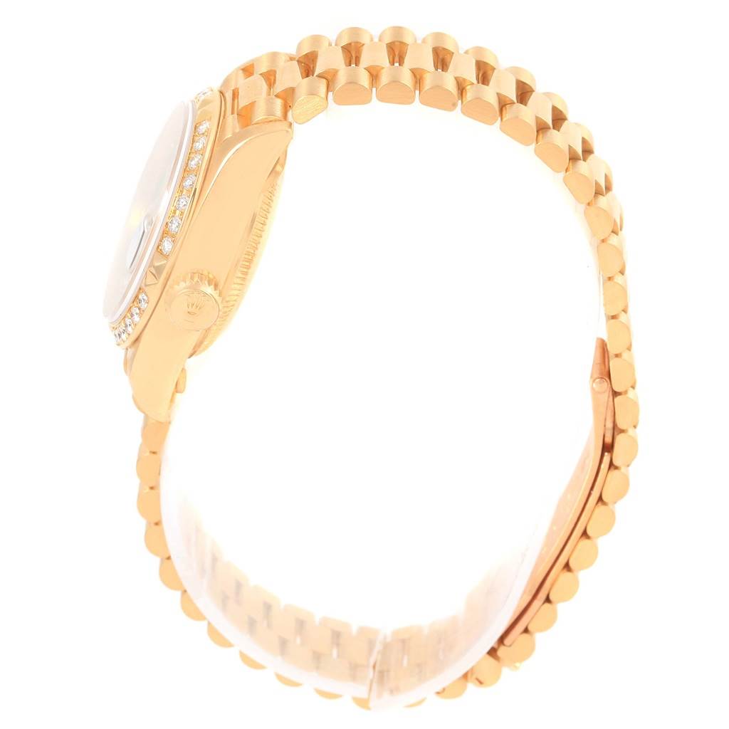 The image shows a side view of a Rolex President 69258 Women's Yellow Gold Black Dial 69258 Women's Yellow Gold Black Dial model watch, highlighting its gold case, diamond bezel, and bracelet.