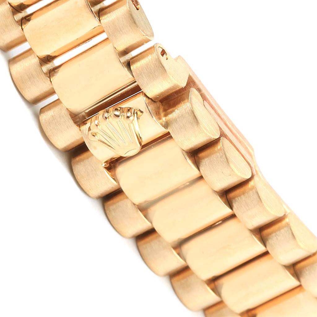 The image shows a close-up of the bracelet of the Rolex President 69258 Women's Yellow Gold Black Dial 69258 Women's Yellow Gold Black Dial model, focusing on the links and the Rolex crown logo.