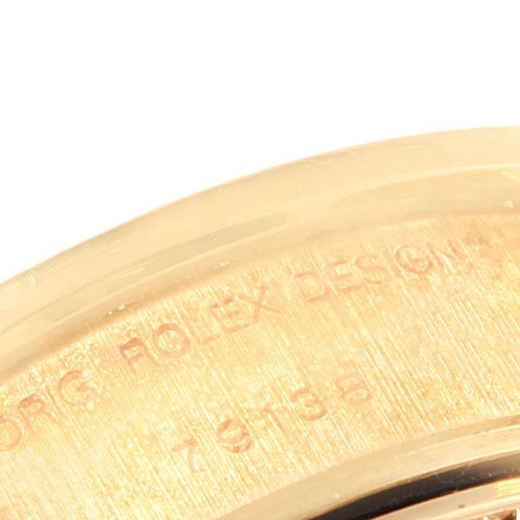 This close-up image shows the engraved serial number and branding on the bezel of a Rolex President 79138 Women's Yellow Gold Champagne Dial 79138 Women's Yellow Gold Champagne Dial model watch.