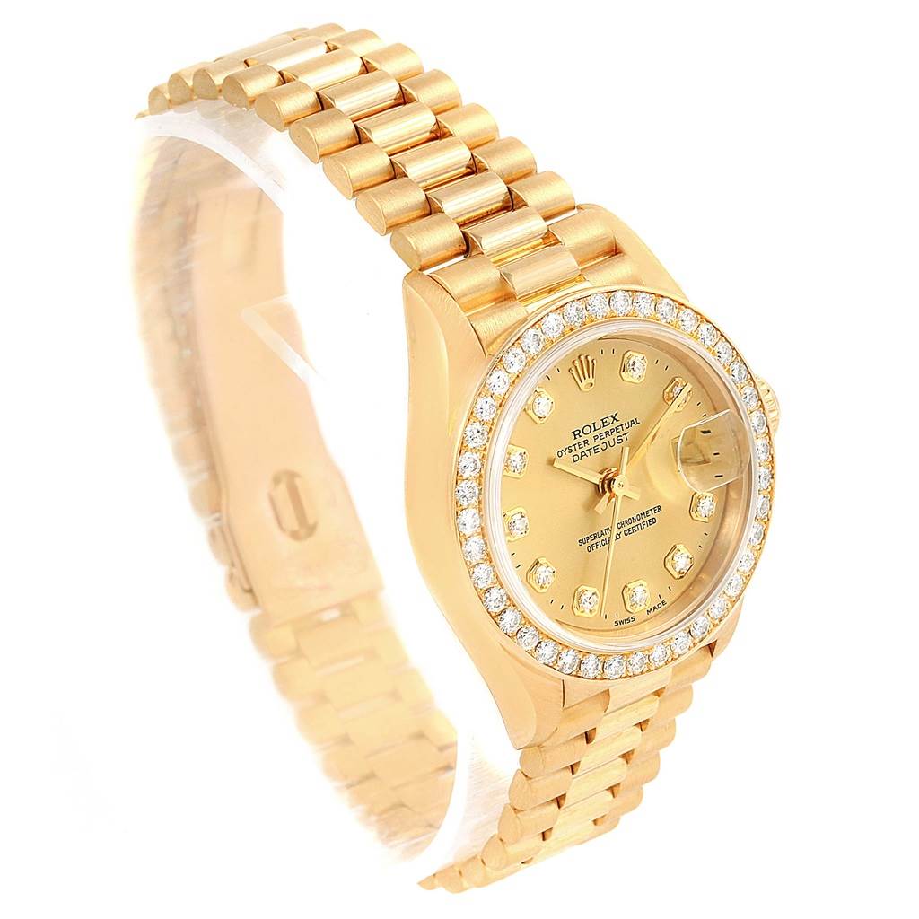 The image shows a side angle view of a Rolex President 79138 Women's Yellow Gold Champagne Dial 79138 Women's Yellow Gold Champagne Dial model watch, highlighting its gold case, bracelet, and diamond bezel.