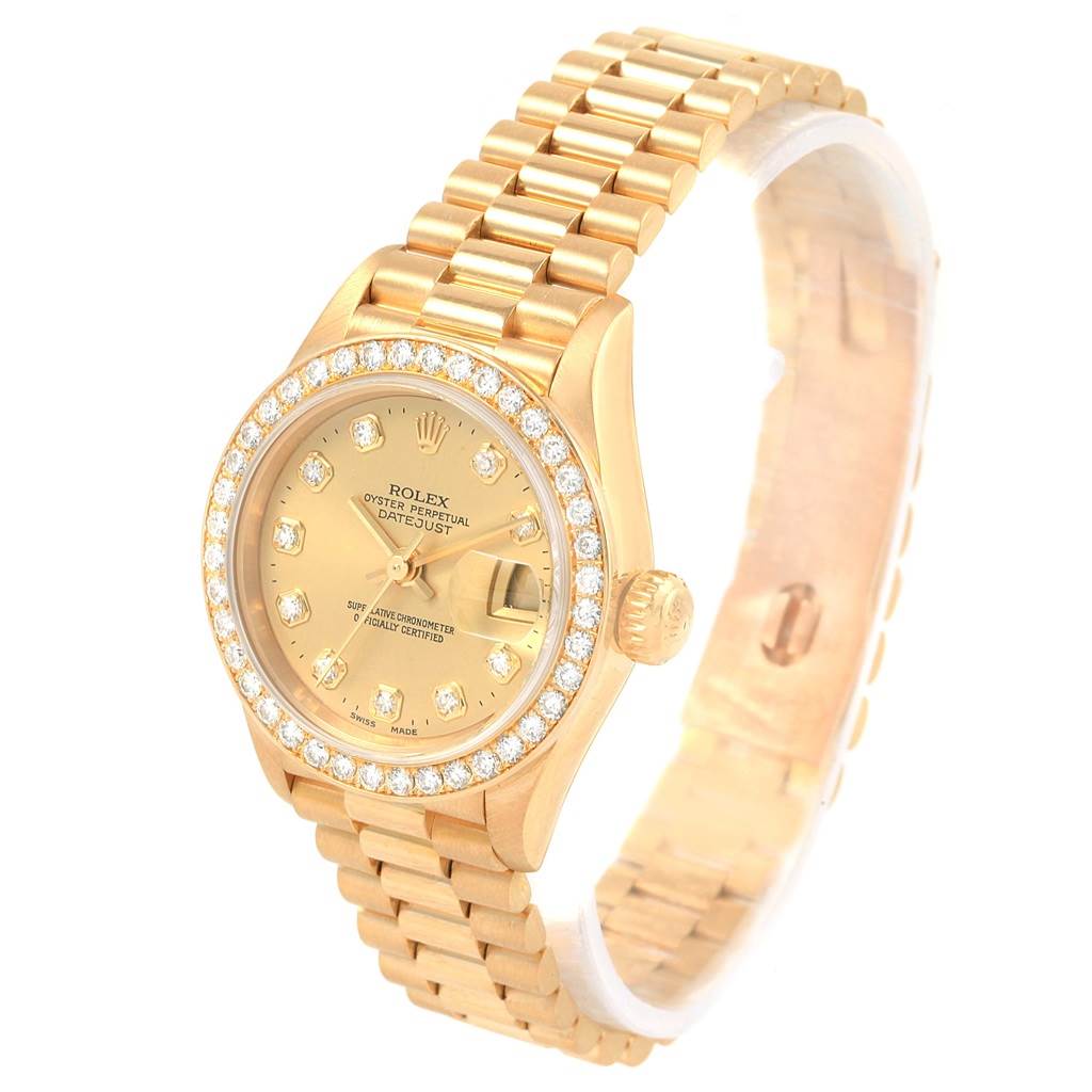 The image shows a gold Rolex President 79138 Women's Yellow Gold Champagne Dial 79138 Women's Yellow Gold Champagne Dial model watch, with a diamond-encrusted bezel and bracelet, viewed from a slight overhead angle.