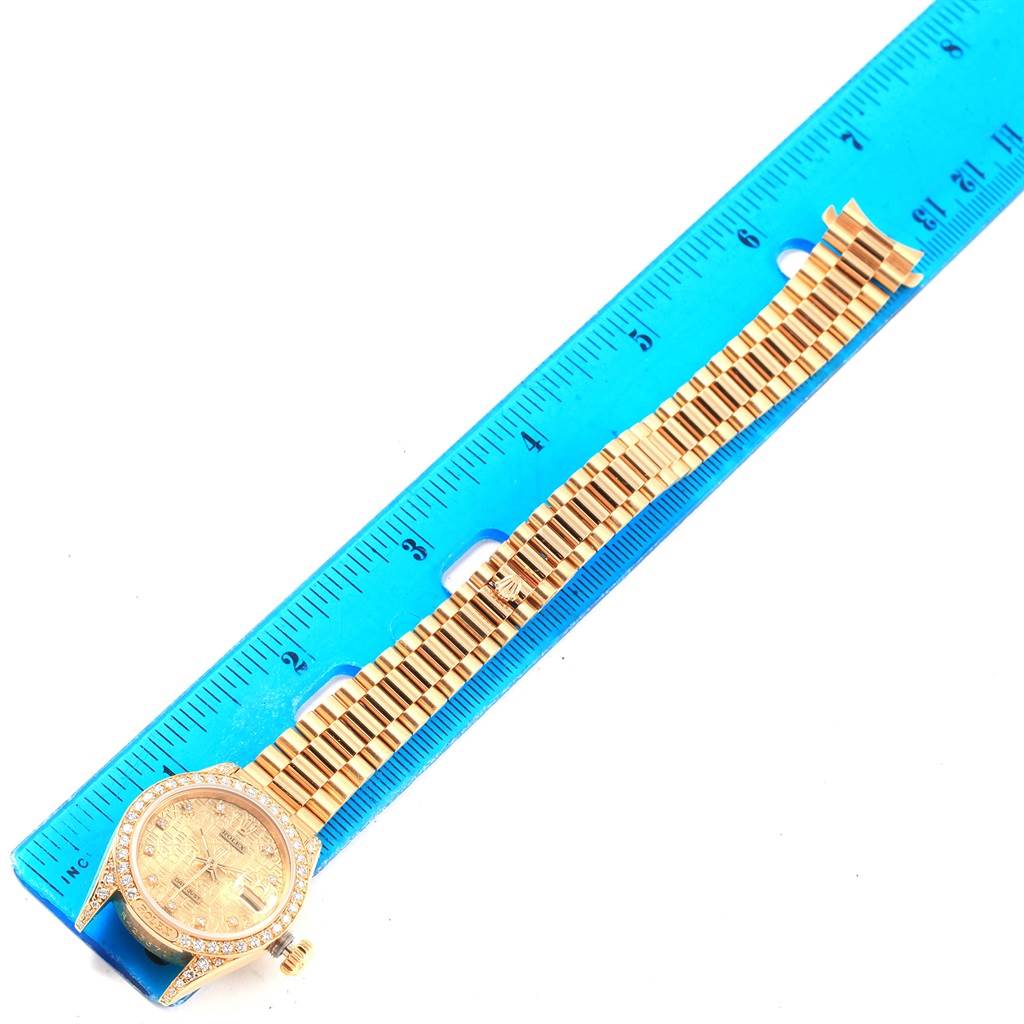 The Rolex President 69158 Women's Yellow Gold Champagne Dial 69158 Women's Yellow Gold Champagne Dial model watch is shown from a top-down angle, displaying the dial, bezel, bracelet, and clasp.