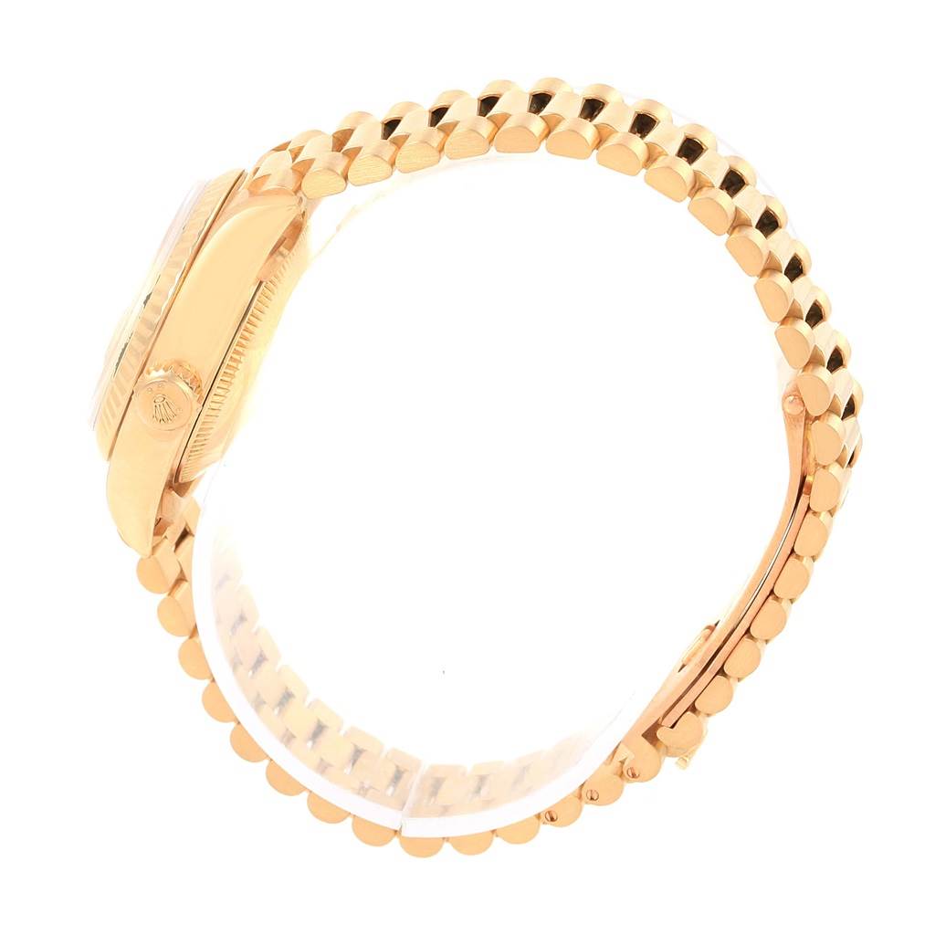 The side view of the Rolex President 69178 Women's Yellow Gold Champagne Dial 69178 Women's Yellow Gold Champagne Dial watch shows its crown, case, and linked bracelet.