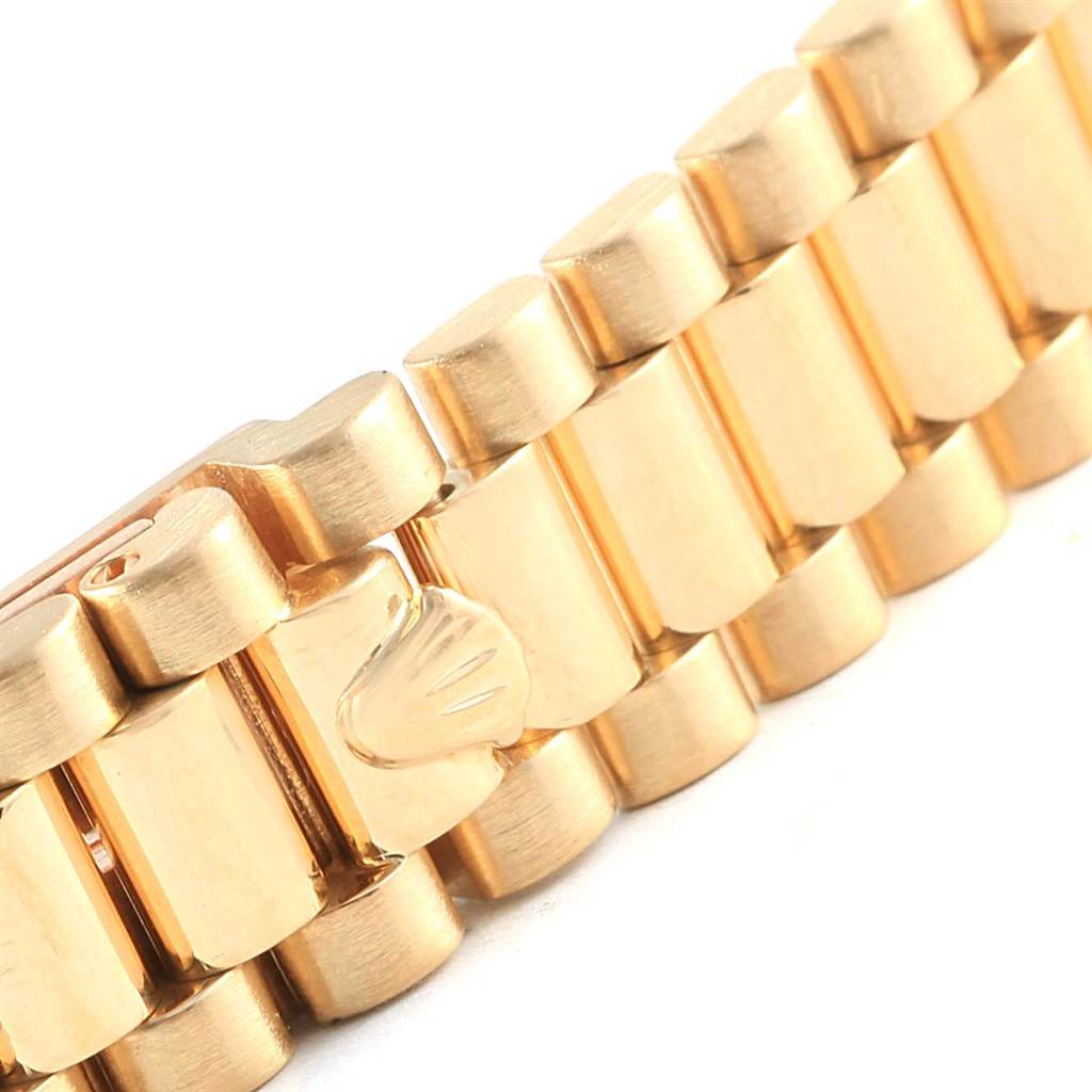 This image shows a close-up of the gold bracelet clasp of a Rolex President 69088 Women's Yellow Gold Blue Dial 69088 Women's Yellow Gold Blue Dial model watch.