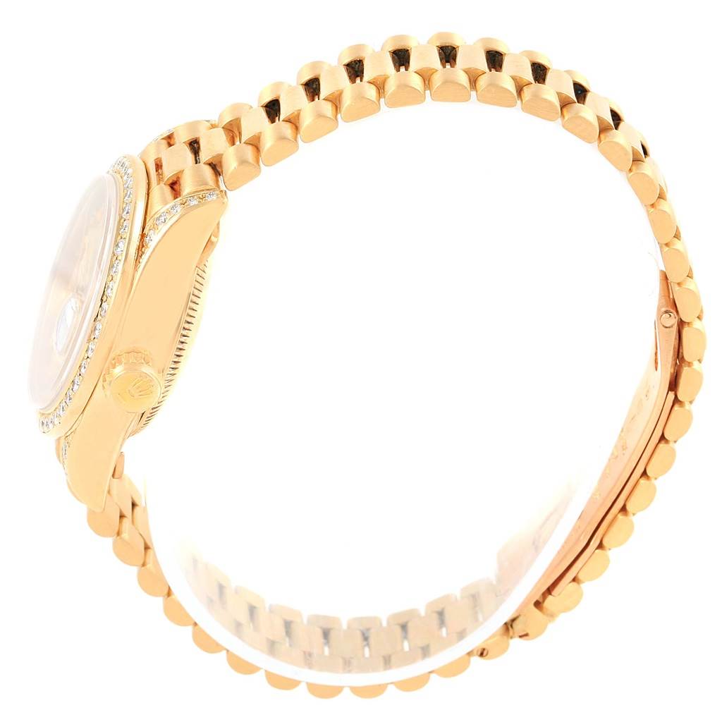 The image shows a side view and band of a Rolex President 69198 Women
s Yellow Gold Champagne Dial 69198 Women
s Yellow Gold Champagne Dial model watch, highlighting its gold links and bezel.