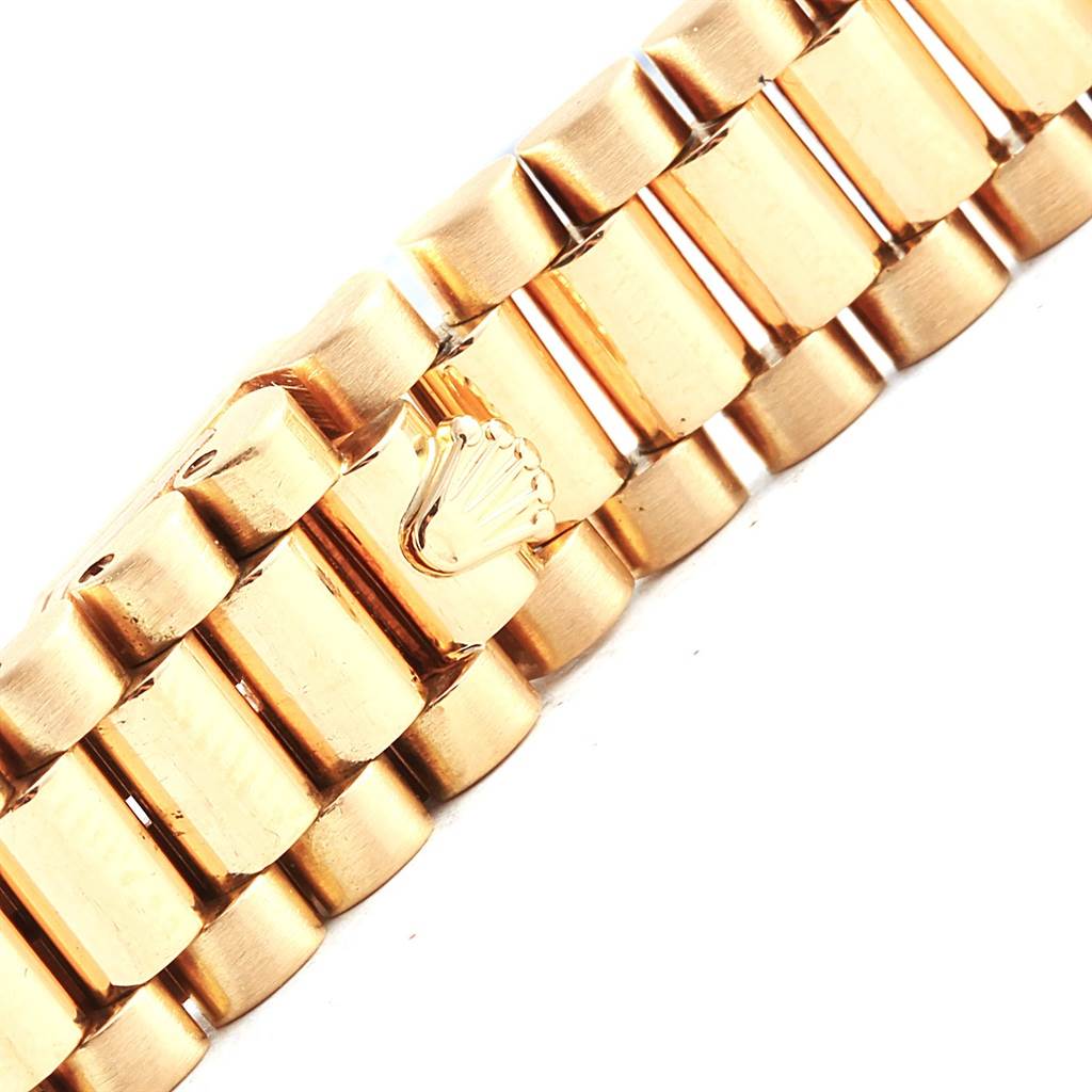 The image shows a close-up of the gold bracelet clasp of a Rolex President 69178 Women
s Yellow Gold Champagne Dial 69178 Women
s Yellow Gold Champagne Dial model watch.