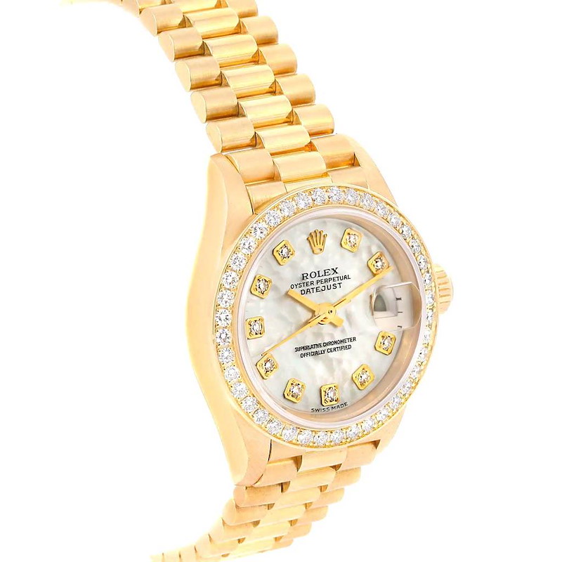 The image shows a tilted angle of a Rolex President model, highlighting its gold bracelet, diamond-encrusted bezel, and dial.